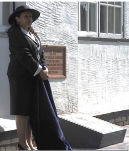 Councillor Razia Daniels, Deputy Lord Mayor of Chester, unveiling the commemorative stone to Billy Congreve. This has been set directly below the foundation stone which was laid on 28 July 1906 as a memorial to Henry Neville Gladstone who donated the Hall – then the Village Institute – to Burton village.