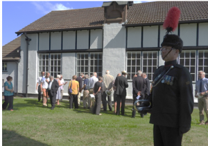 Bugle Major Mark Douglas and some of visitors and local residents attending the unveiling.